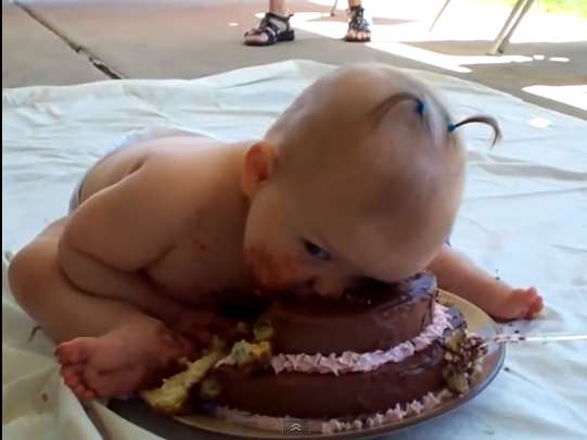 Baby eating her first cake