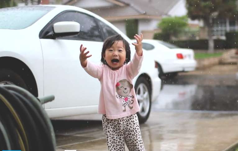 This little girl experiences rain for the very first time