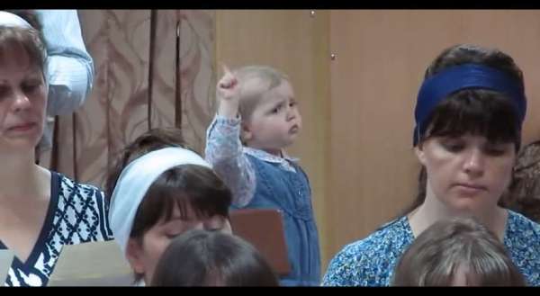 Passionate Baby Girl Conducts a Church Choir