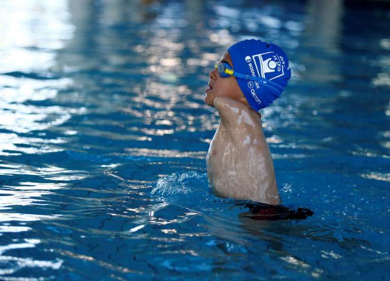 six year old born without arms wins gold medal