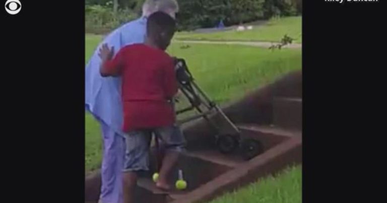 boy helps woman struggling up stairs
