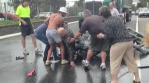samaritans rescue man pinned under burning bike