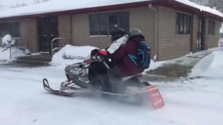 pharmacist delivers prescriptions snowmobile