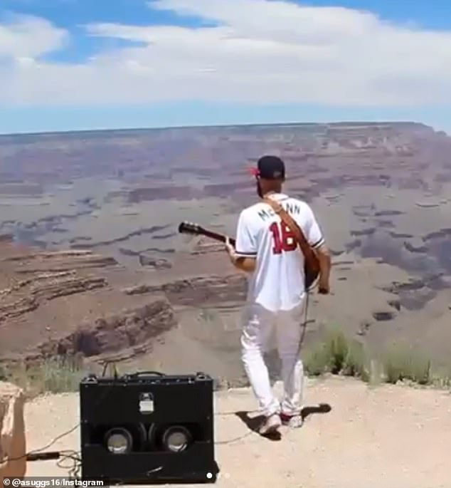 musician plays electric guitar at grand canyon