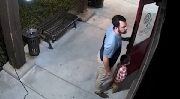 father and son stand guard at candy store
