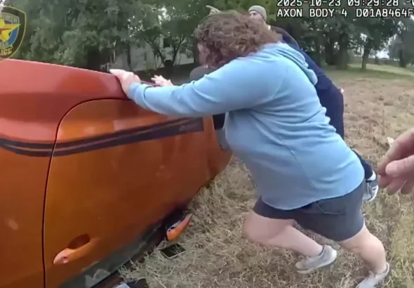 officers and bystanders lift car